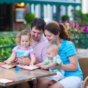 Family with two children sitting around a table